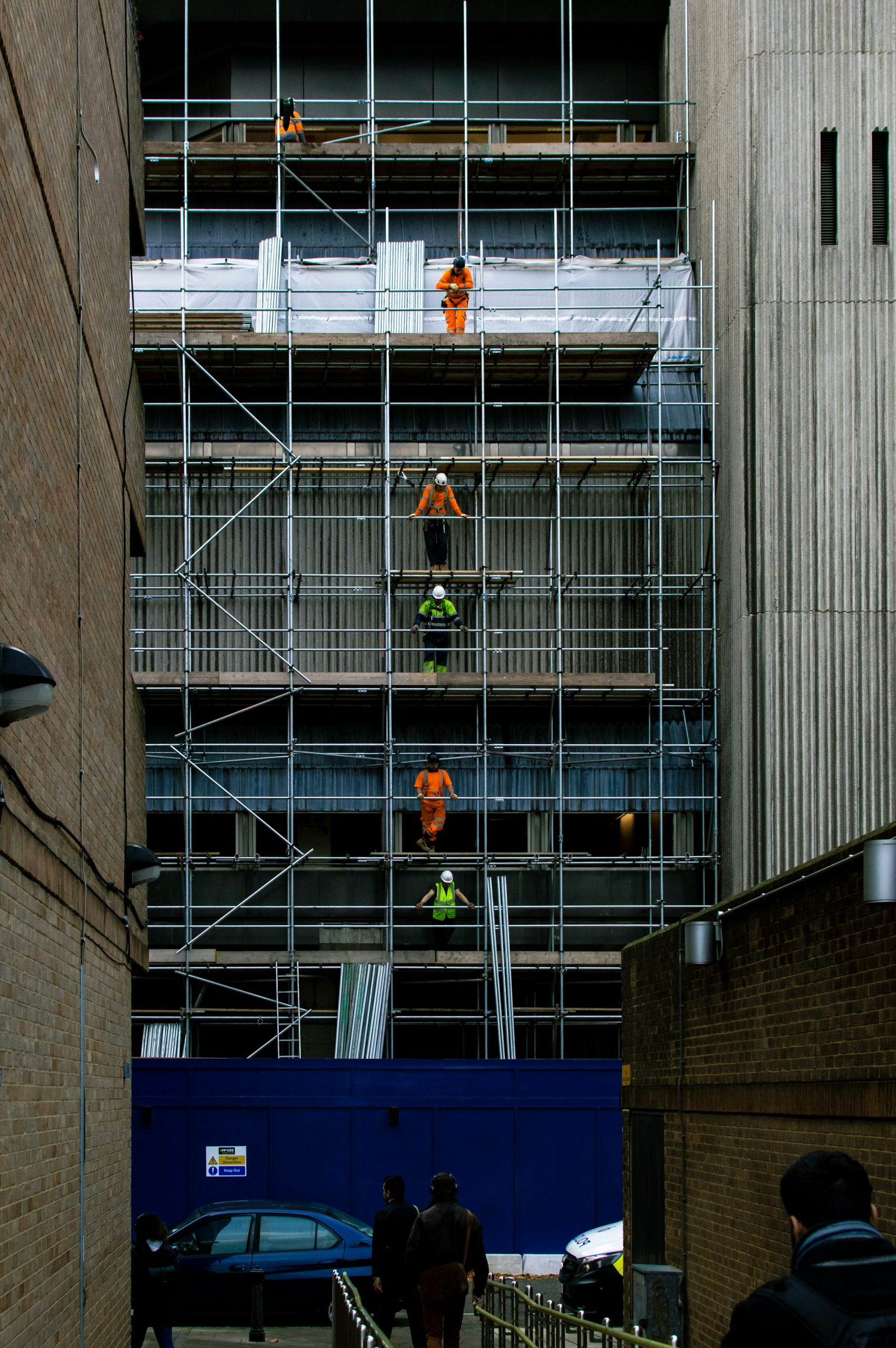 Scaffolders working across several levels of scaffolding on a London building