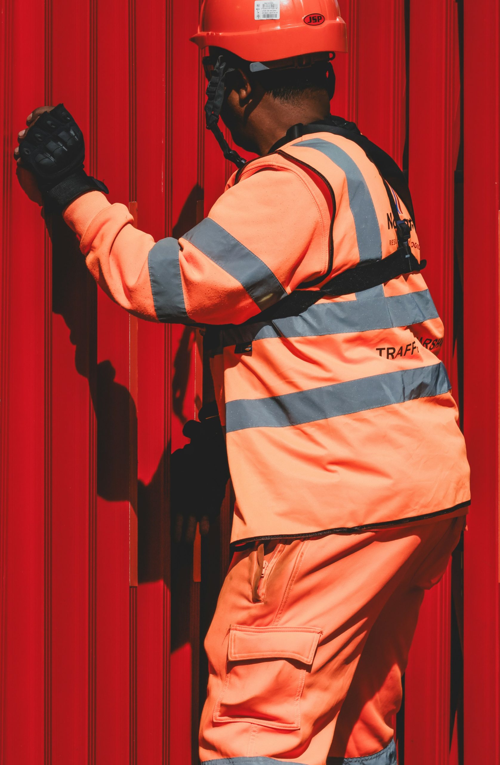 Site worker in orange hi-vis and a hard hat in London
